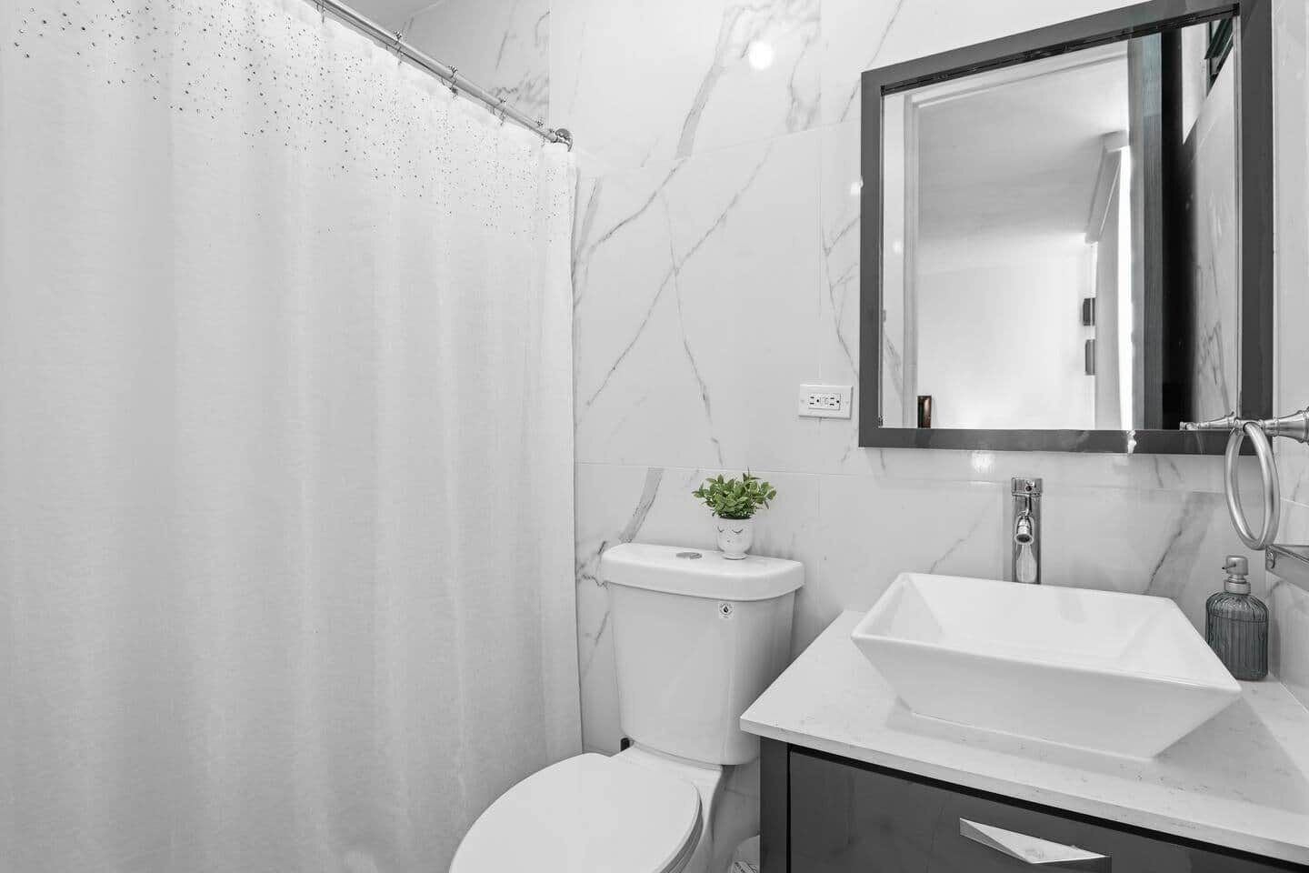 Un baño moderno con ducha, inodoro y lavabo.