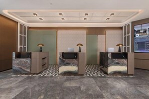 A reception area with three desks, each with a computer and a lamp. The floor has a patterned tile design. - Meilun Hotel, Baymax Center, Dongting, Wuxi (Wuxi)