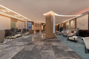 A modern hotel lobby with a marble floor, seating areas, and a reception desk. - Meilun Hotel, Baymax Center, Dongting, Wuxi (Wuxi)