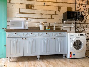 A kitchen with a microwave, sink, and washing machine. - Bella Serra Gramado Residence (Gramado)
