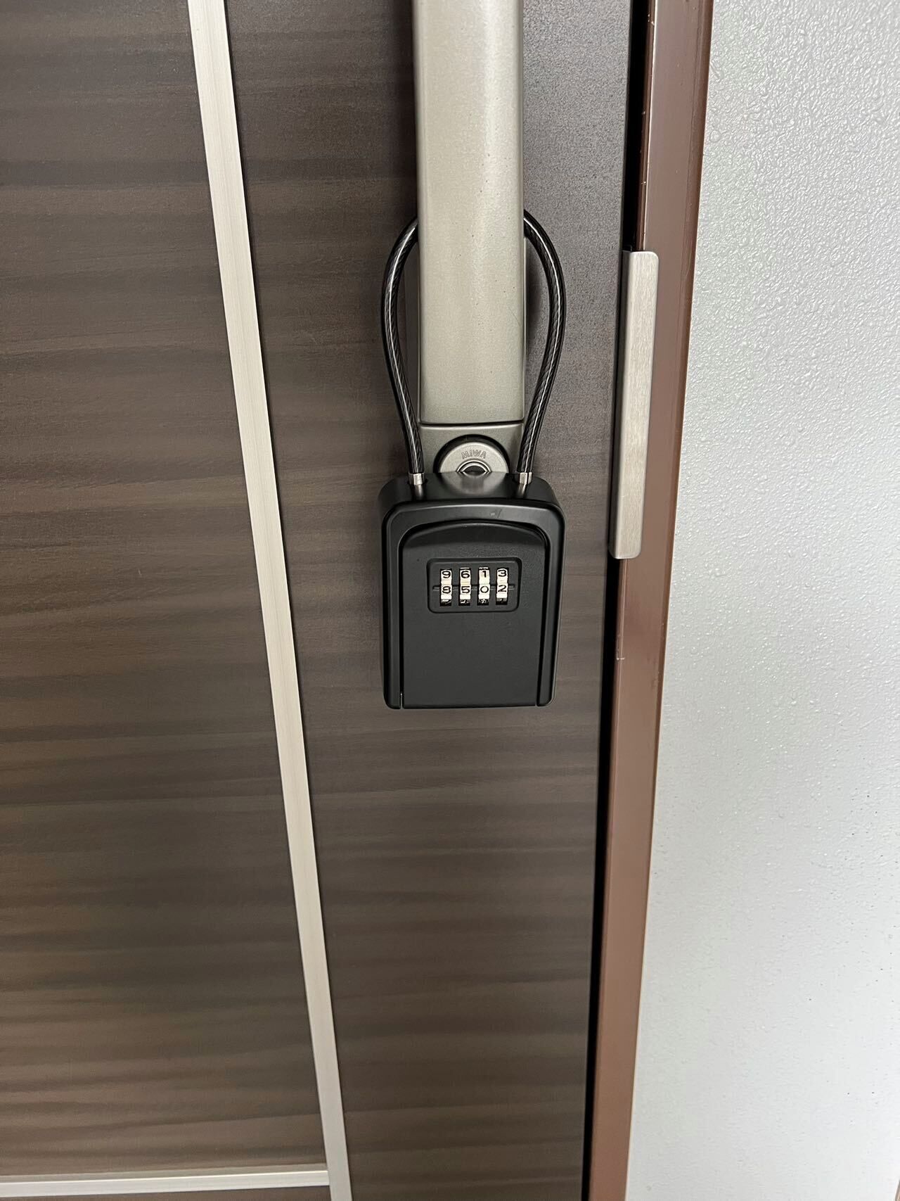 A door with a combination lock and a keyhole.