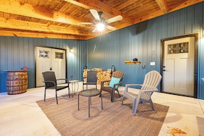 A room with a ceiling fan, two doors, and four chairs arranged around a small table. - Secluded Luxe Lake House, Fire Pit, Hot Tub, Sauna, Private Dock (Bryson City)