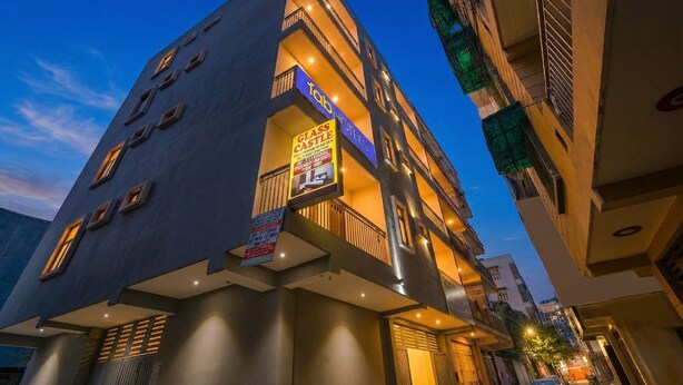 A multi-story building with balconies, a glass castle sign, and a Tab Hotels sign. - Fabhotel Glass Castle (New Delhi)