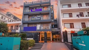 A multi-story hotel with a prominent 'fabHOTELS' sign, a name 'HOTEL Admire Ebresswy', and a staircase leading to the entrance. - FabHotel Expressway 135 - Near By KJR Hospital (Noida)