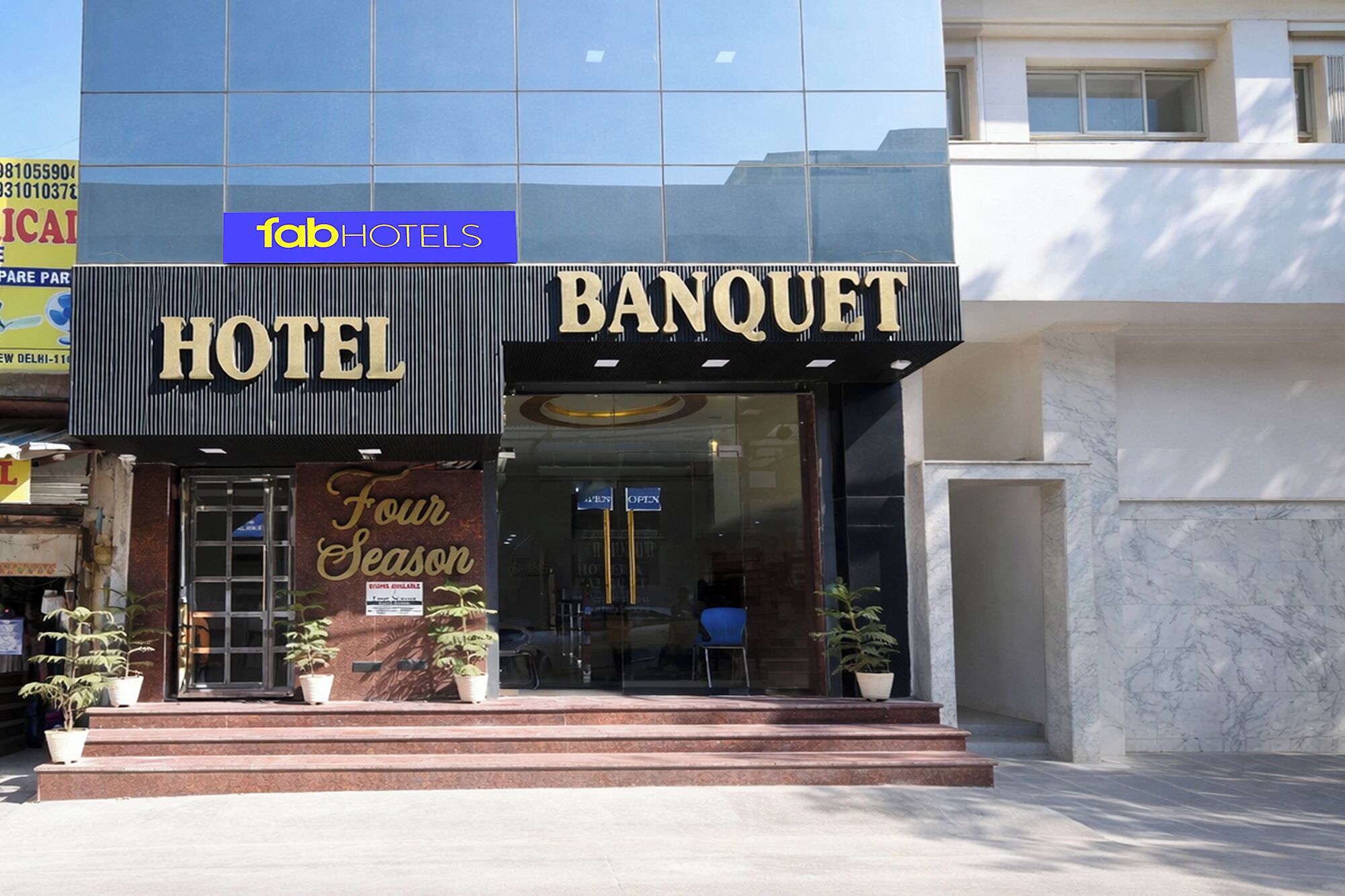 A hotel with a 'Banquet' sign, a 'Four Season' sign, and a 'fbHOTELS' logo.