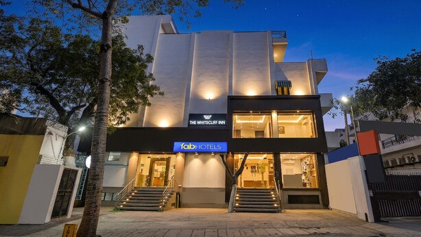 A modern building with a sign for 'fab hotels' and 'The Whitecliff Inn' at night. - FabHotel The White Cliff Inn - Near Max Hospital Saket (New Delhi)