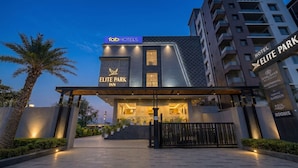 A hotel entrance with a modern design, a sign for 'Elite Park Inn,' and a 'Maritime Garden Pool Rooms' sign. - Fabhotel Elite Park Inn (Jaipur)