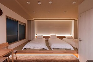 A modern hotel room with a large bed, a desk, and a window. - Sunshine Inn 456 (Tokyo)