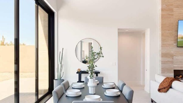 A modern dining area with a large table, chairs, and a mirror. - Nyx - Near Troon North Golf & Scottsdale Quarter (Scottsdale)