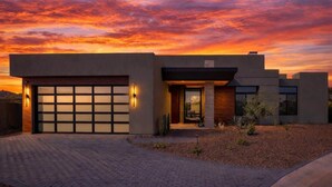 A modern house with a garage, a driveway, and a landscaped garden. - Nyx - Near Troon North Golf & Scottsdale Quarter (Scottsdale)