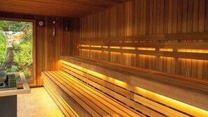 A sauna with wooden benches and a bench heater. - Bishopstrow Hotel and Spa - Small Luxury Hotels of the World (Bishopstrow)