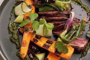 A plate of food with grilled vegetables and steak. - Bishopstrow Hotel and Spa - Small Luxury Hotels of the World (Bishopstrow)