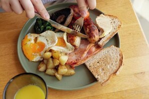 A plate of breakfast food including eggs, sausages, bacon, toast, and potatoes. - Bishopstrow Hotel and Spa - Small Luxury Hotels of the World (Bishopstrow)