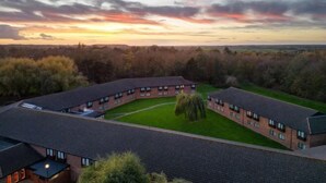 A large, circular building with multiple windows and a central courtyard. - Delta Hotels by Marriott Peterborough (Orton Waterville)