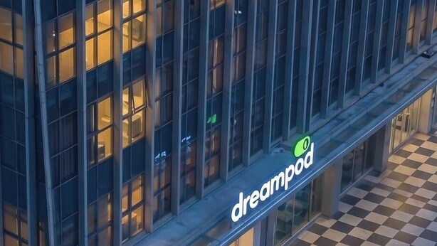 A modern building with a glass facade, a checkered floor pattern, and a visible 'dreampod' sign. - Dreampod Soekarno Hatta Airport (Tangerang)