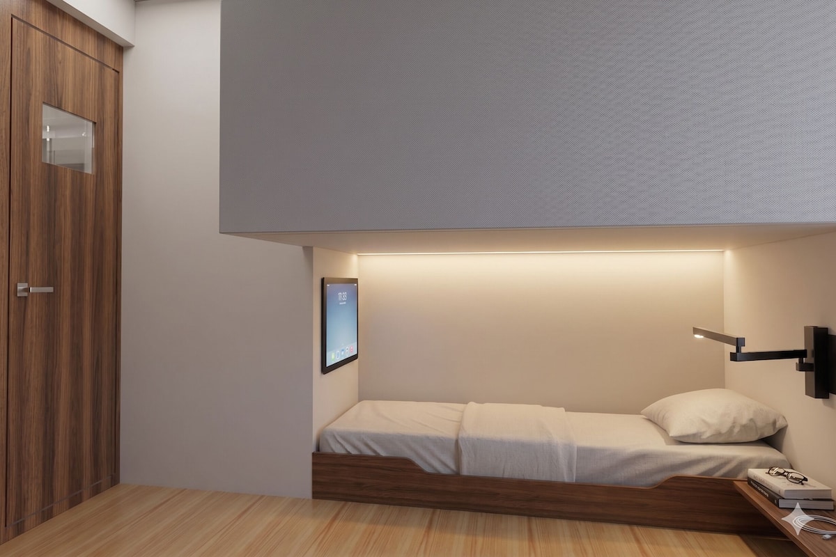 A bedroom with a bed, a bedside table, a wall-mounted TV, and a wooden wardrobe.