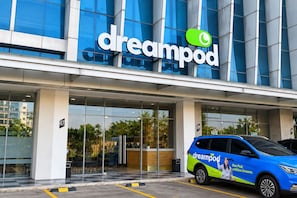 Un edificio moderno con fachada de vidrio y el logotipo 'dreampod'.