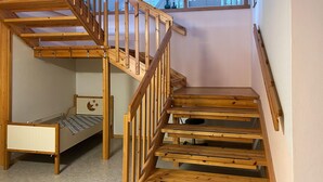 A wooden staircase with a bunk bed and a desk. - 3 bedroom cozy apartment in Verma (Verma)