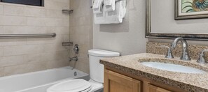 A bathroom with a bathtub, toilet, and two sinks with granite countertops. - Wyndham Sea Gardens 2 BR Condo - Beach Access! (Pompano Beach)