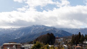 A mountainous landscape with a church and residential buildings.