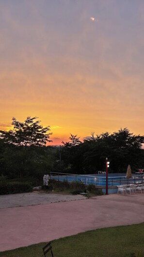 Seasonal outdoor pool, open 8:30 AM to 8:30 PM, pool umbrellas