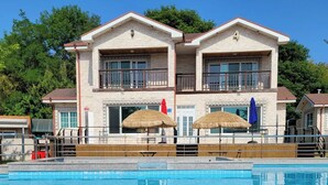A two-story building with a swimming pool in front. - pacific (Gyeongju)
