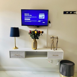 A flat-screen TV mounted on a wall displaying a welcome message. - Modern & Cozy Retreat Game Room, Family-Friendly (North Las Vegas)