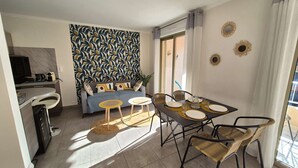 Un soggiorno moderno con un divano, un tavolino da caffè e un tavolo da pranzo.