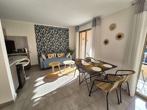 Ein modernes Wohnzimmer mit Sofa, Couchtisch und Esstisch.
