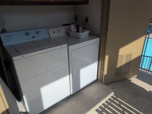 A compact laundry area with a Whirlpool washer and dryer, a small sink, and a window providing natural light. - Serene Canyon-Side 2BR/2Bath + Loft Sleeps 6 @ Central SD near tech hubs & UTC (San Diego)
