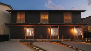 A modern two-story building with a covered entrance and a small outdoor seating area. - GAON (Beppu)