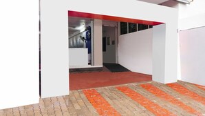 A modern building entrance with a red carpet leading to a door. - Collection O Ramanathapuram (Ramanathapuram)