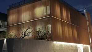 A modern building with a flat roof and a metal railing on the upper level. - AFTER RAIN HOTEL (Chiang Mai)