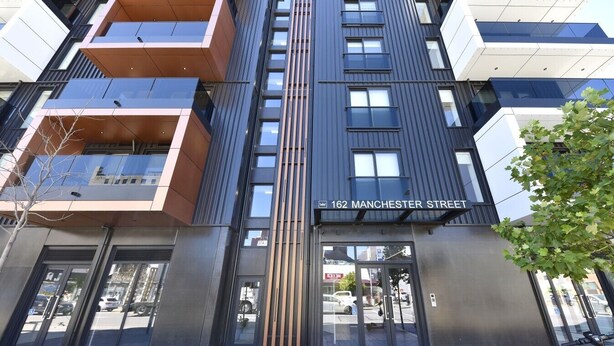 A modern building with a sign reading '162 Manchester Street.'