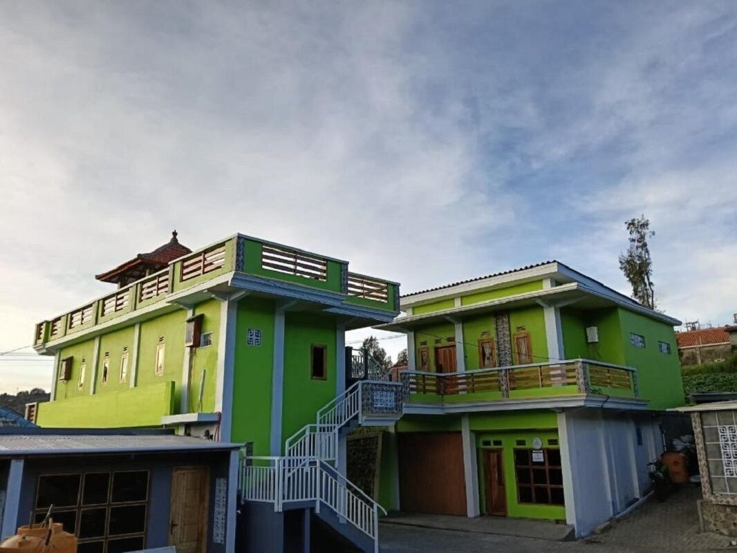 A two-story building with a balcony and a staircase.