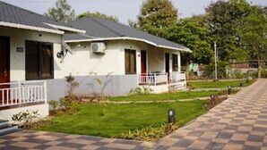 A row of single-story houses with a checkered pathway leading to the entrance.