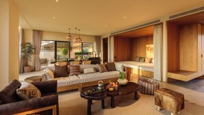 A spacious living area with a sofa, coffee table, and a dining area with a wooden bench. - bynaked Boluo Huizhou (Huizhou)