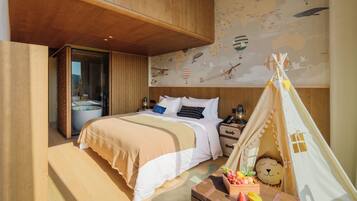 A bedroom with a large bed, a wooden ceiling, a map mural, a tent, and a nightstand with a lamp.