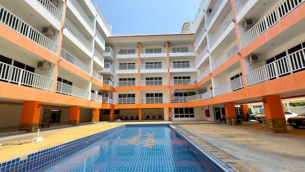 A multi-story building with a central courtyard featuring a swimming pool. - Pool-View Studio with Balcony - New Nordic VIP 4, Pratumnak (Muang Pattaya)