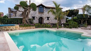A stone villa with a swimming pool, surrounded by lush greenery and a well-maintained garden. - If you want to combine calmness and art , Arthouse is for you (ζακυνθος)