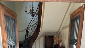 A staircase with a wrought iron railing leading to a landing.