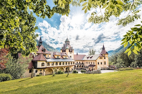 A large, historic building with multiple towers and a courtyard.