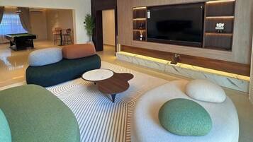 Family Apartment, Balcony, City View | Living area | Flat-screen TV