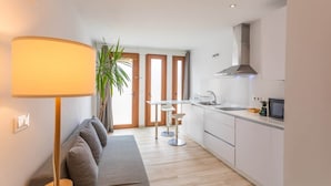 A modern kitchen with a dining area, a sofa, and a lamp. - 1 beach line. Malabau N2 (Tarifa)