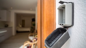 A wall-mounted electrical box with a cable connected to it.