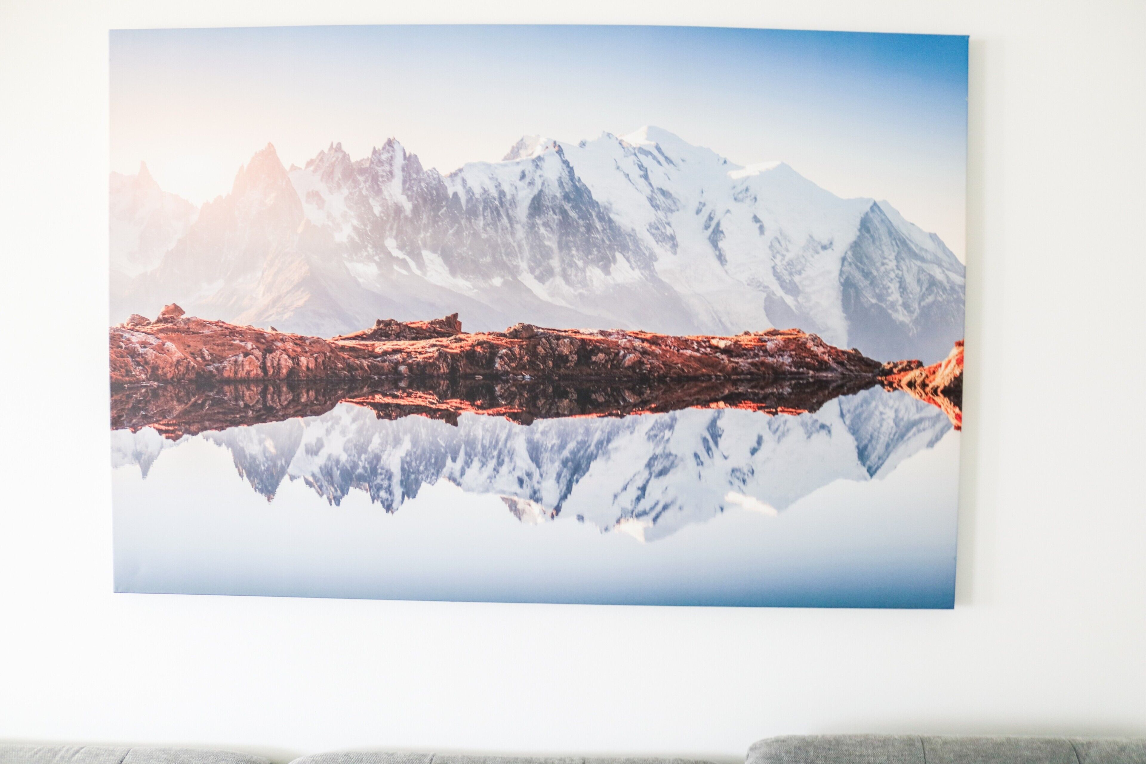 A mountain landscape with a clear reflection in a body of water.