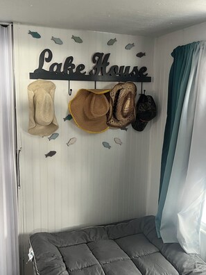 A wall with a 'Lake House' sign and various hats and bags hanging on hooks. - Walk up to this houseboat on beautiful Norris Lake, Maynardville Tennessee. (Maynardville)