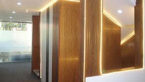 A modern interior with wooden paneling and recessed lighting. - Niharika Heights Luxury Hotel (Bengaluru)