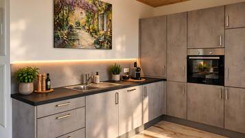 A modern kitchen with a large island, built-in appliances, and a decorative painting above the sink.