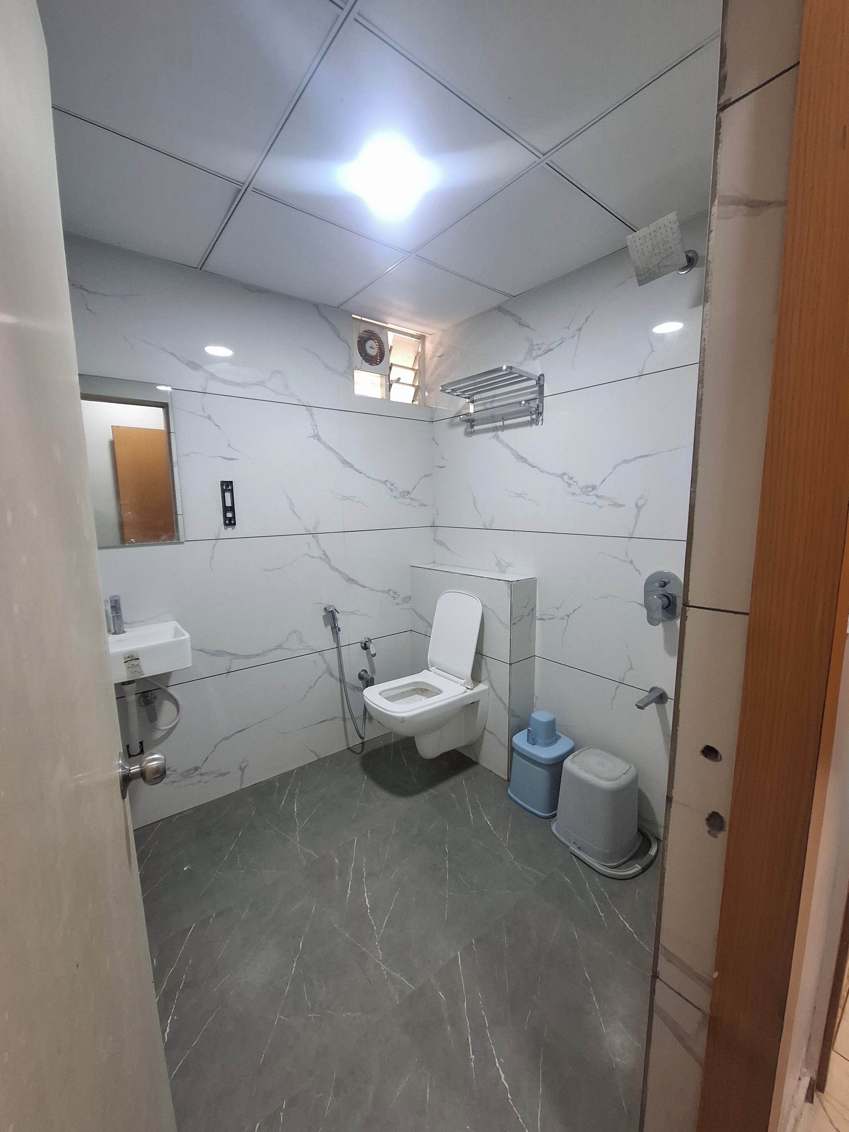 A modern bathroom with a toilet, sink, and shower.